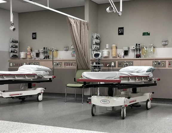 This image shows a hospital floor with beds.