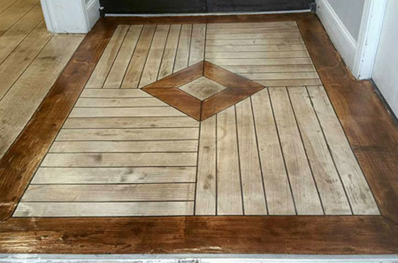 This image shows a floor that has a wood Stamped Concrete Flooring.