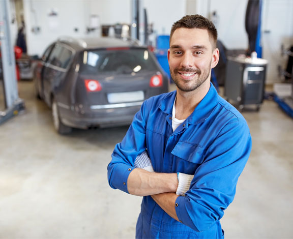 This image shows a mechanic smiling.