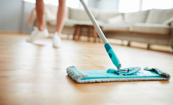 This image shows a woman mopping the floor.