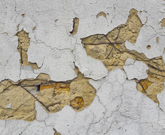 This image shows cement peeling off from a pool deck.