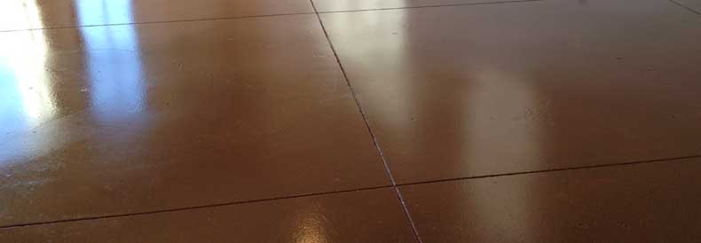 This image shows a stained concrete floor of a garage.