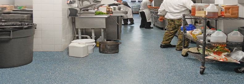 This image shows a commercial kitchen with flake epoxy floor.