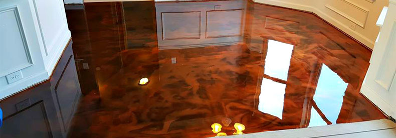 This image shows a living room with a metallic epoxy floor.